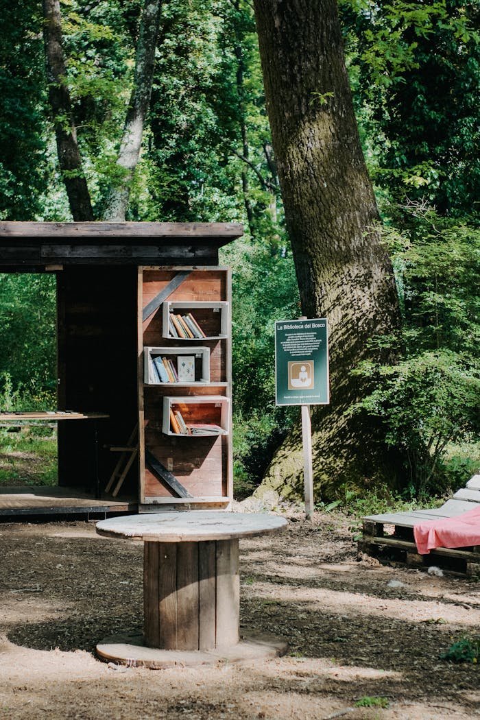 A cozy outdoor book exchange setup in a lush green park, inviting readers to share literature.